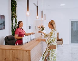 Dental receptionist helps patient